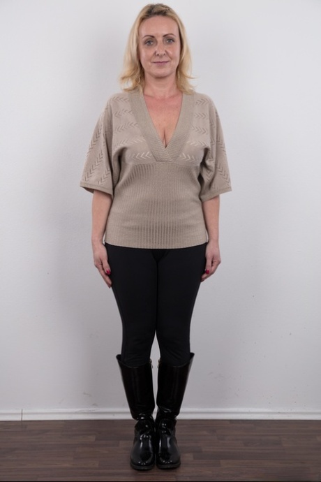 Middle-aged blonde lady Gerlinda stands totally nude after disrobing