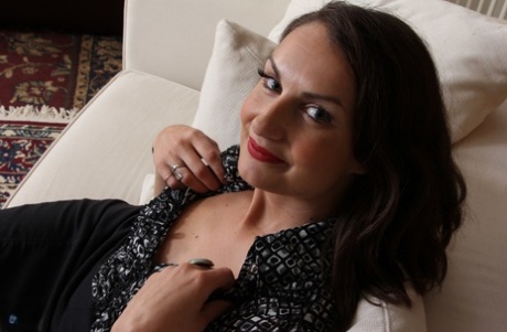 Mature American housewife disrobes as she prepares to masturbate