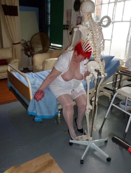 Older redhead nurse Valgasmic Exposed gets banged by a dildo wielding skeleton