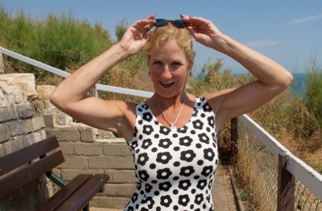 Mature blonde Molly MILF exposes her tits and underwear while at the beach