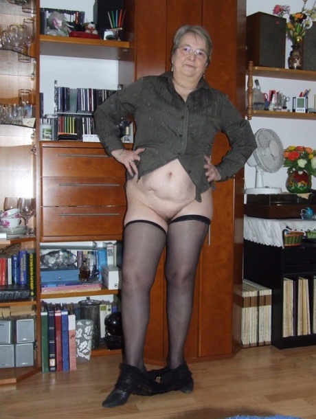 Chubby granny with glasses Sybille stripping naked & toying her fat pussy